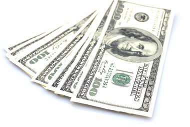 One hundred dollar bills fanned out on a white background.