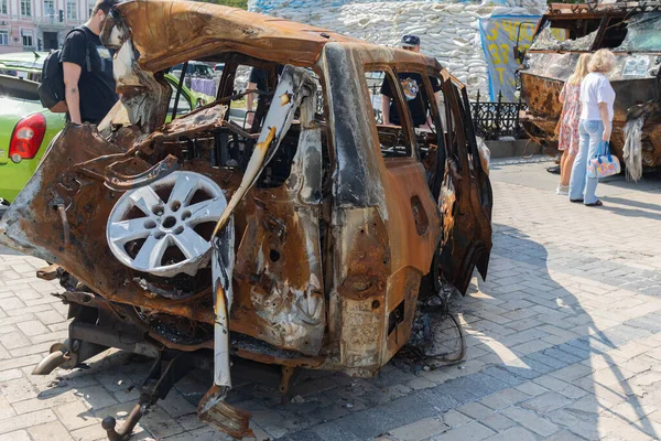 View of the burnt civilian car. Rusty car doors. Stop war. Rusty metal. War in Ukraine.