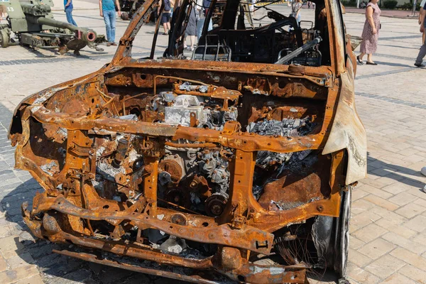 View of the burnt civilian car. Rusty car doors. Stop war. Rusty metal. War in Ukraine.