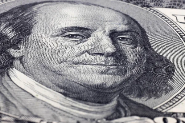 Macro close up of Ben Franklin's face on the hundred dollar bill.
