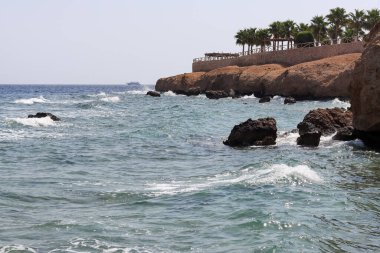 Splashing waves on the shore of the Red Sea in Egypt. Holidays at sea in Egypt.