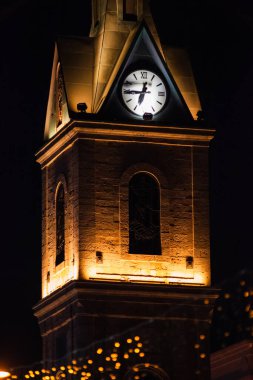 Siyah arka planda Bokeh ışıkları olan saat kulesi