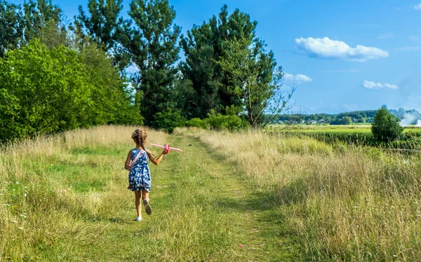 Beautiful Little Girl Run Grass Launches Red Toy Plane Little — Stok Foto