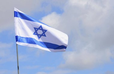 The Israeli flag, the Star of David in the rays of the bright sun 