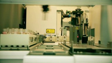 Automated laboratory for blood testing. Moving line with test tubes. PCR Test Covid 19, Antibody test