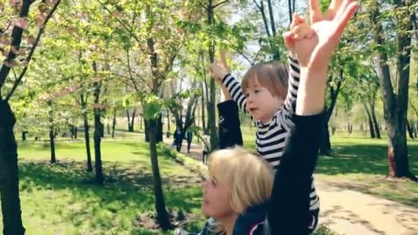 Little Boy Striped Shirt Sits Shoulders Blonde Mom Family Admires — Stockvideo