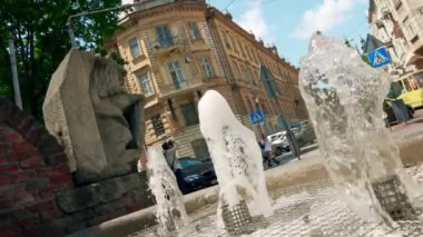 Haziran 2022. Lviv. Ukrayna. Şehrin sokaklarındaki çeşme, şehir hayatı. Ağır çekim. Yaz günü.