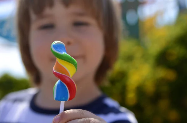 Little Boy Eats Colored Candy Stick Bright Lolipop Hands Child — Foto de Stock