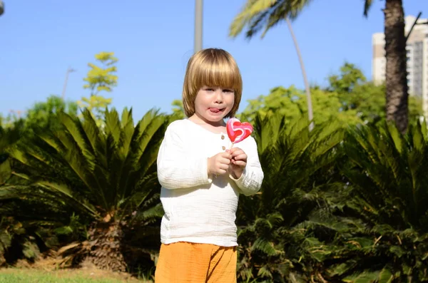 Portrait Cute Positive Little Boy Heart Shaped Candy Concept Mother — Φωτογραφία Αρχείου