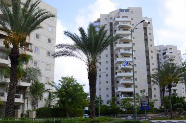 Israel Rishon LeZion August 2022 Beautiful residential building. Modern housing. Israel - high-rise building, flowering trees. Concept: nice place to live, real estate purchase