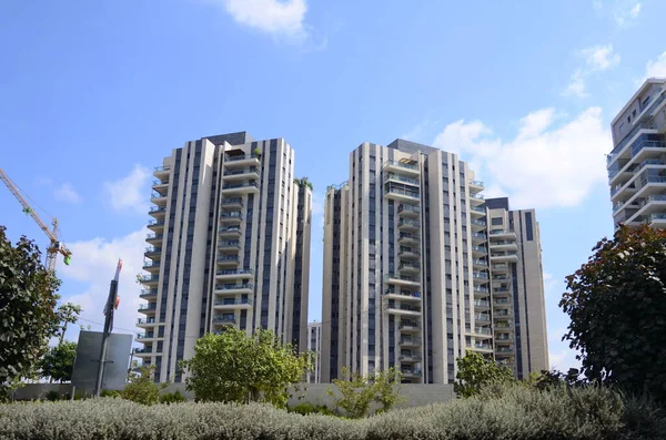 Beautiful residential building surrounded by a garden. Modern housing. Israel - high-rise building, flowering and palm trees. Concept: nice place to live, real estate purchase