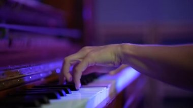 Close-up female hands playing the piano. Fingers on piano keys. Classical music performance, solfeggio lesson, professional. slow motion