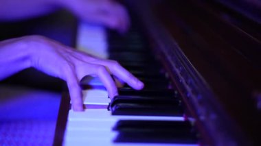 Close-up female hands playing the piano. Fingers on piano keys. Classical music performance, solfeggio lesson, professional. slow motion
