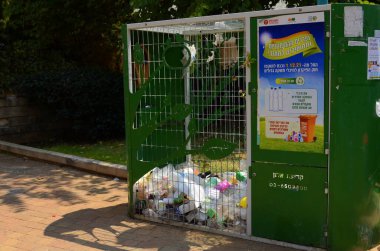  Israel, Rishon LeZion August 2022 The metal net box of container for collection of the plastic bottles for recycle. bottle recycling collection unit. Ecological responsibility education concept.