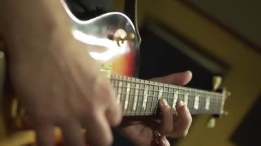 Solo blues guitar Electric Guitar Playing. Close-up. male hands hit the strings, solo guitar lesson, concert rehearsal, live show.