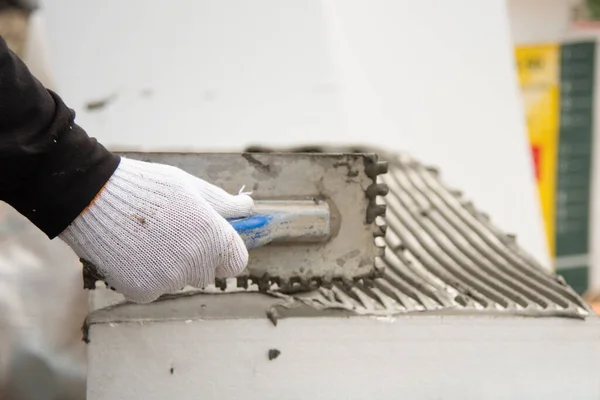 Close Worker Hand White Glovs Trowel Applying Glue White Rigid — Stock Photo, Image