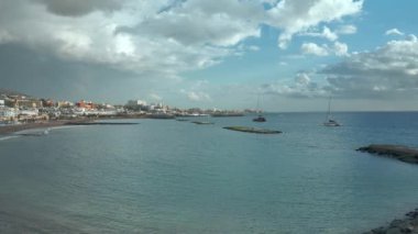 View of the port of Costa Adeje Tenerife South south the Canary Islands. The sky is blue, the Atlantic is blue-green.
