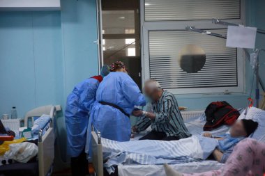 BUCHAREST, ROMANIA - 15 Ekim 2021: Kişisel Koruyucu Ekipman (PPE) giyen tıp çalışanları, Coronavirus salgını nedeniyle aşırı kalabalık olan St. Pantelimon hastanesinin acil servisindeki hastalara bakıyorlar.