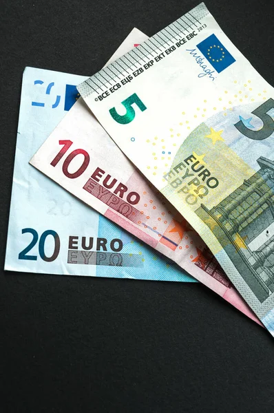 Euro Bank notes, includes 20-, 10- and 5-euro notes, bills on black background