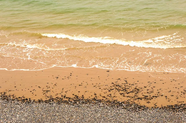 Ocean Wave Washes Over Sand and Pebble Beach, Incoming Tide, full frame, no people, concept or design,background, wallpaper, 