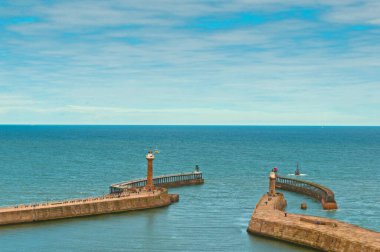 Whitby harbour, the North Pier, breakwater in summer, blue sky flat sea, safety for shipping, North Yorkshire coast