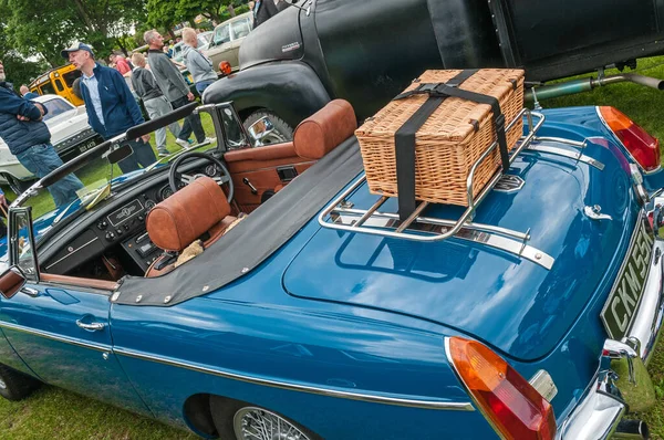 Hull, East Yorkshire, England, 11th June 2017, Classic British MG Sports Car, close up showing wicker picnic basket on boot of blue MGB Roadster, blue MGB Roadster with boot rack and brown leather interior