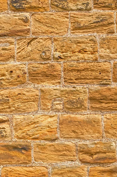 Rough warm stone wall background for design or concept