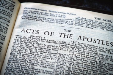 Close up of Holy Bible page, shallow depth of field with focus on book chapter heading, The Acts of the Apostles