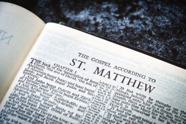 Close up of Holy Bible page, shallow depth of field with focus on book chapter heading, St Matthew