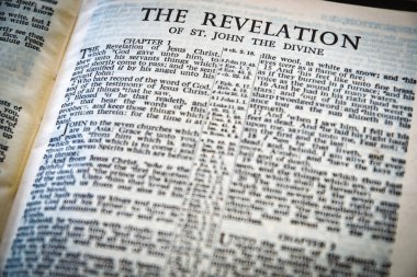Close up of Holy Bible page, shallow depth of field with focus on book chapter heading, The Revelation