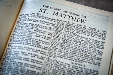 Close up of Holy Bible page, shallow depth of field with focus on book chapter heading, St Matthew