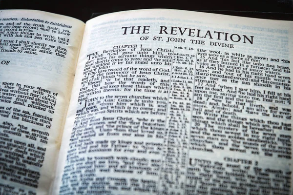 Close up of Holy Bible page, shallow depth of field with focus on book chapter heading, The Revelation