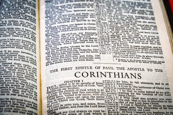 Close up of Holy Bible page, shallow depth of field with focus on book chapter heading, Corinthians