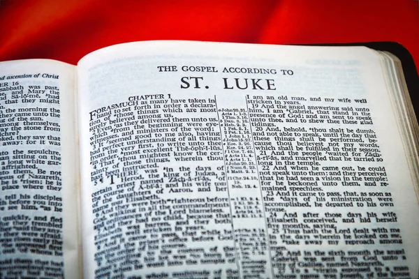 Close up of Holy Bible page, shallow depth of field with focus on book chapter heading, St Luke