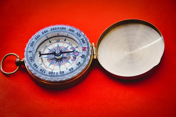 Vintage compass on red background, no people with copy space for concept or design