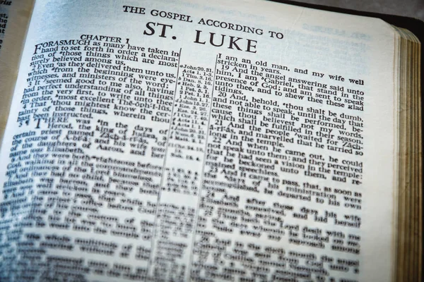Close up of Holy Bible page, shallow depth of field with focus on book chapter heading, St Luke