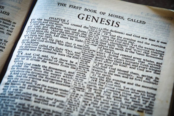 Close up of Holy Bible page, shallow depth of field with focus on book chapter heading, Genesis