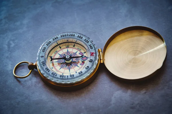 Vintage compass close-up on grey background, no people with copy space for concept or design