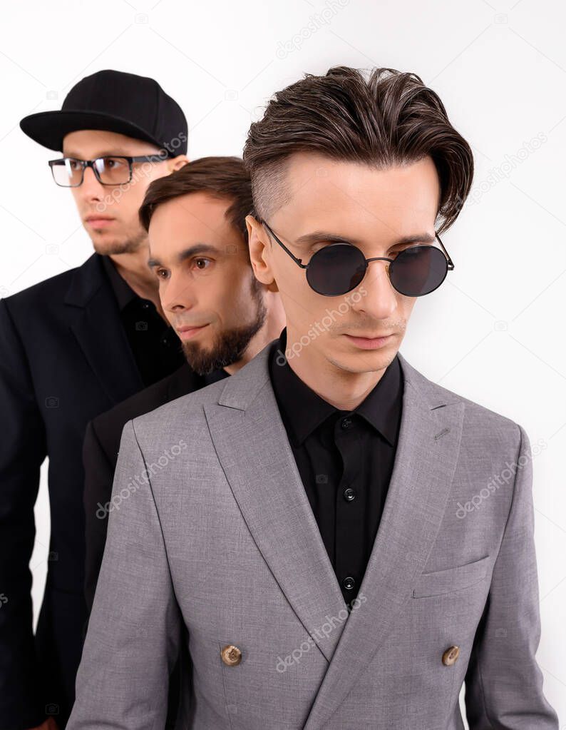 Three caucasian young guys posing stylishly 