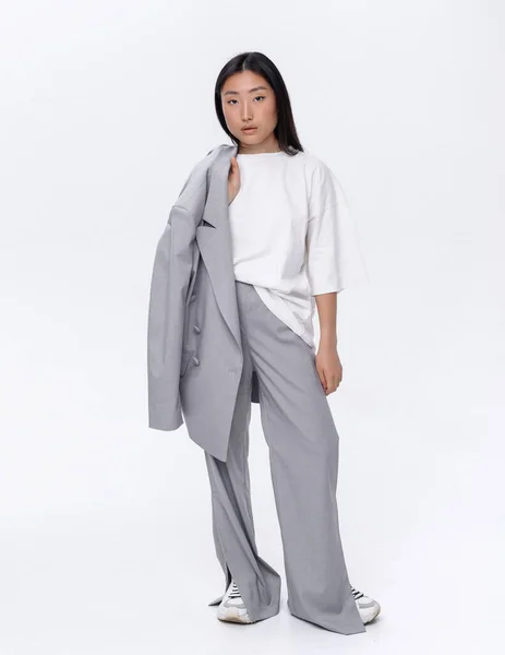 Beautiful Asian Girl Gray Suit Poses White Wall Photo Studio — Stock fotografie