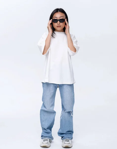 Beautiful Asian Girl White Shirt Blue Jeans Poses White Wall — Stockfoto