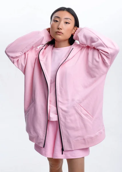 Beautiful Asian Girl Pink Casual Tracksuit Posing White Wall Photo — Stok fotoğraf