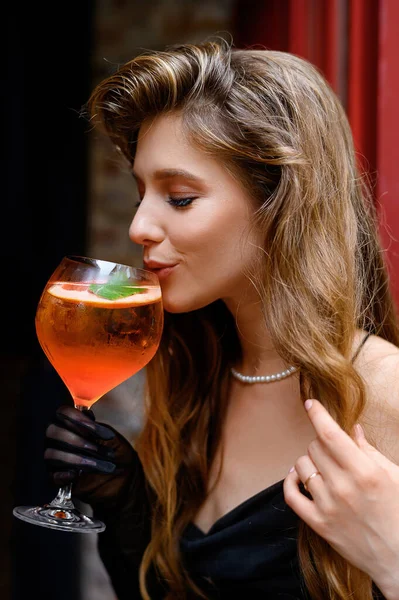 Beautiful Caucasian Girl Black Dress Smiling Drinking Aperol Cocktail Bar — Stock Photo, Image