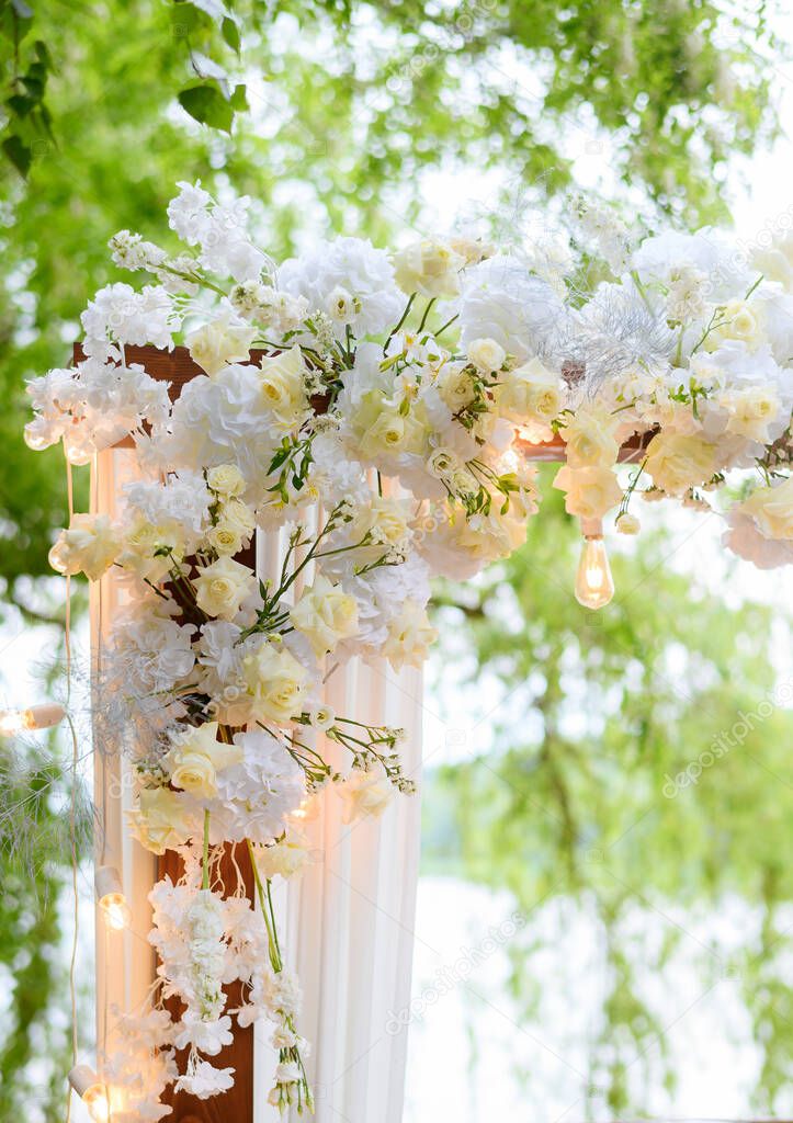 Beautiful summer wedding arch for ceremonies in the forest against the background of the lake