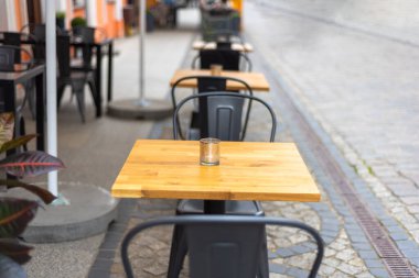 Restaurant interior Tables near a restaurant Close up shot of empty cafeteria or restaurant tables with chairs on street