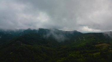 Aerial time lapse of fog over hills, after rain