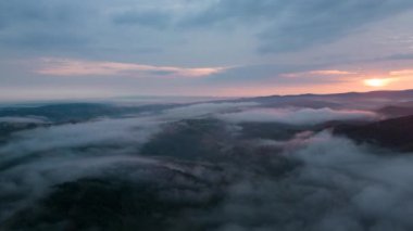 Aerial time lapse of fog over hills, after rain