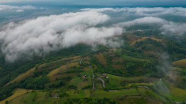 Aerial time lapse of fog over hills, after rain