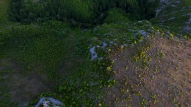 Aerial view of karst landscape, in Romania, with valleys and cliffs, at sunset