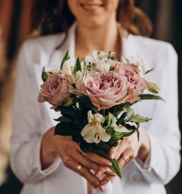 Bridal bouquet of violet and white roses, as well as heleny eucalyptus leaves. Wedding, holiday